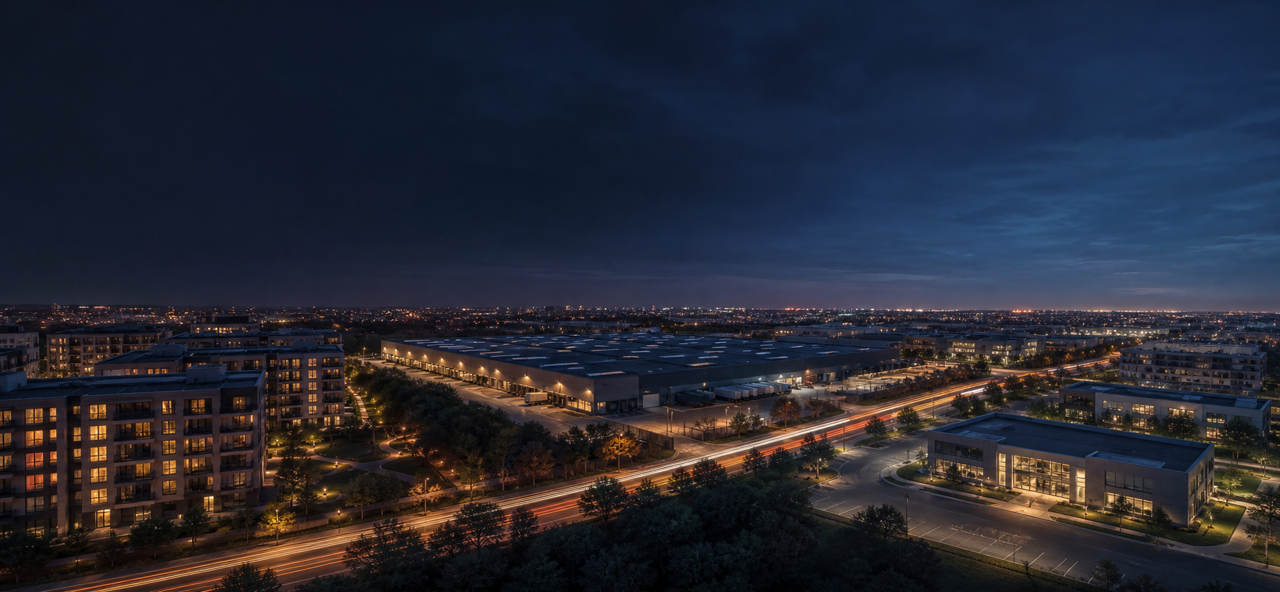 Illustrative nighttime panorama of a connected multifamily, industrial, and medical property district